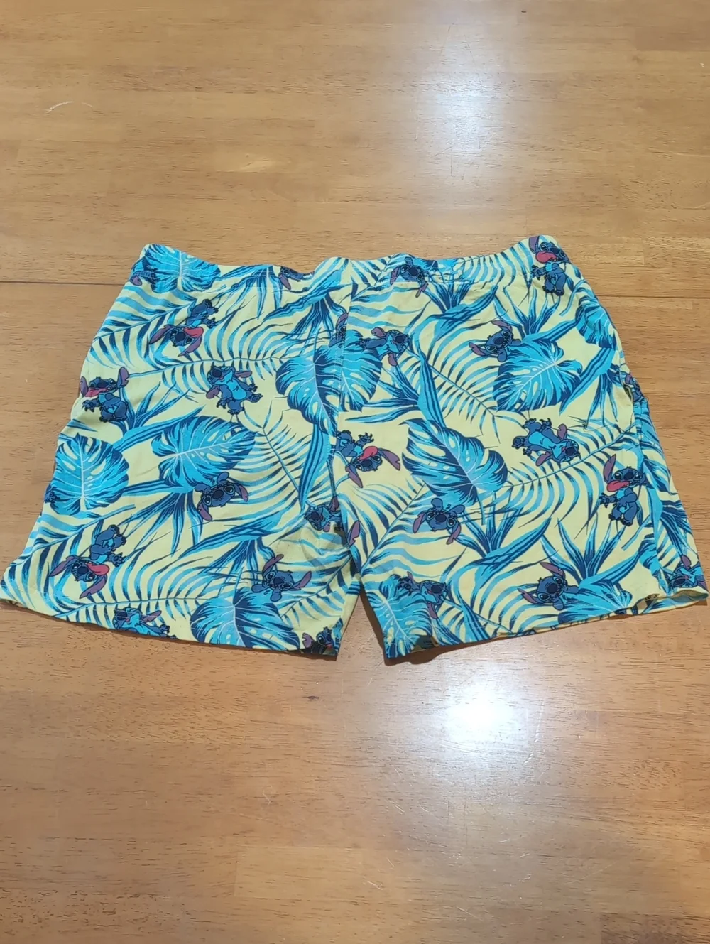 Disney Men's Yellow Stitch Shorts with Blue Tropical Leaf Print